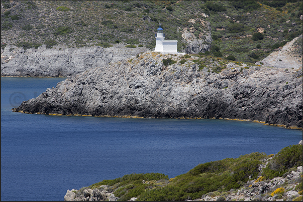 The lighthouse under the cliffs of Hora, the capital of island The lighthouse under the cliffs of Hora, the capital of island