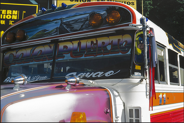 Colon Town on the Caribbean side. Typical colored buses Colon Town on the Caribbean side. Typical colored buses