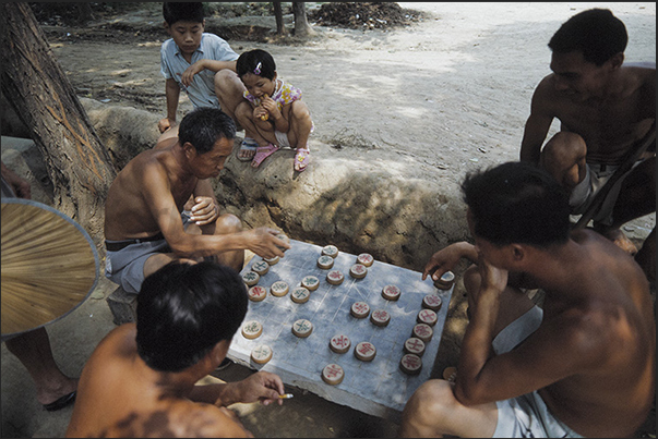 Village near Mongin, a chess-like game very popular in rural villages Village near Mongin, a chess-like game very popular in rural villages