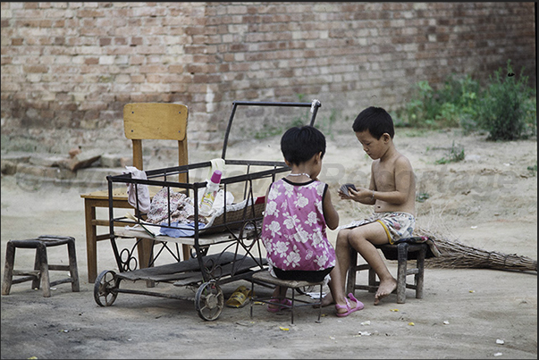 Mongin Village. Kids play with cards