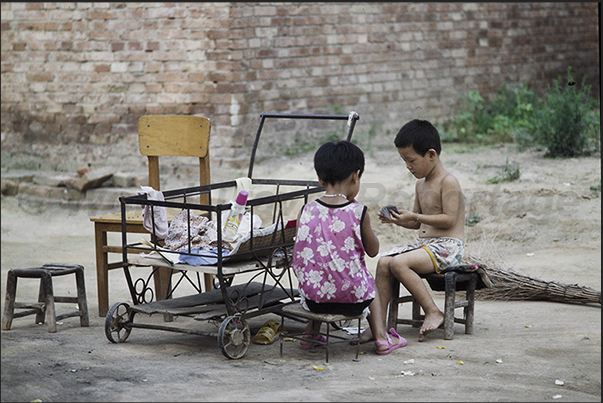 Mongin Village. Kids play with cards Mongin Village. Kids play with cards