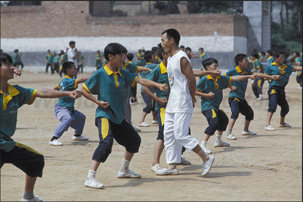 Shaoling. Martial Arts Schools. The kids learn kung fu in the school squares