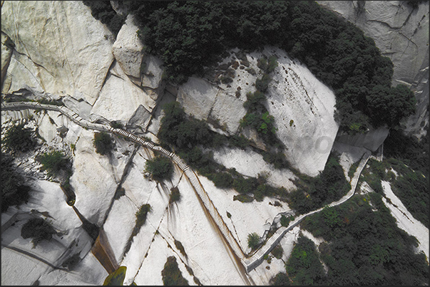 Huashan Mountains (near Xian). The long and steep stairways that leading on the top of the five peaks of Mount Hua Huashan Mountains (near Xian). The long and steep stairways that leading on the top of the five peaks of Mount Hua