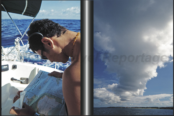 Sailing to Anguilla Island. Clouds are formed on the island by recreating its profile in the sky