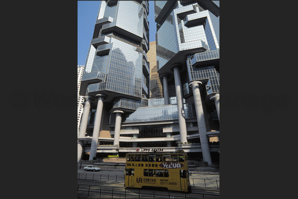 Modern architecture looms over the ancient tram