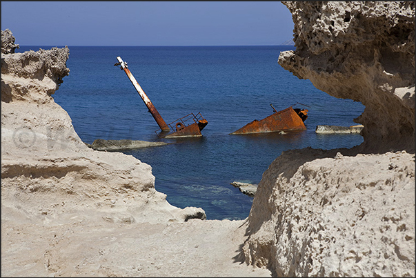 Rocky beaches of Sarakinikos. Wreck of a small merchant Rocky beaches of Sarakinikos. Wreck of a small merchant