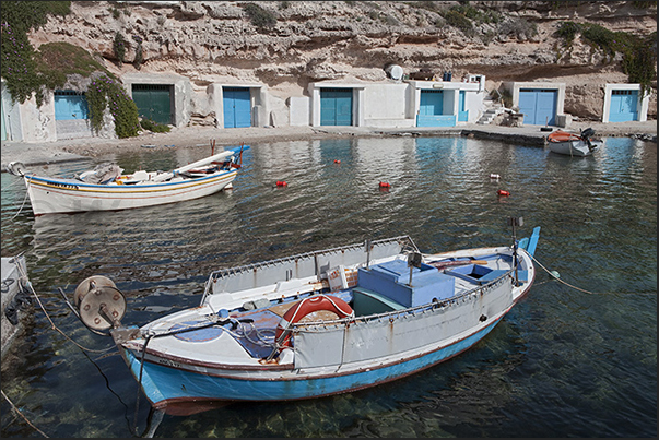 Mandrakia. The storage rooms for fishing equipment carved into the rock of the cliff