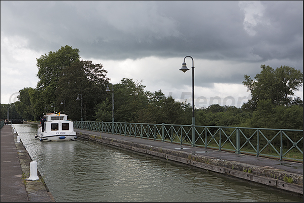Passage on the fluvial bridge of Digoin a navigable bridge that crosses the river Loire Passage on the fluvial bridge of Digoin a navigable bridge that crosses the river Loire