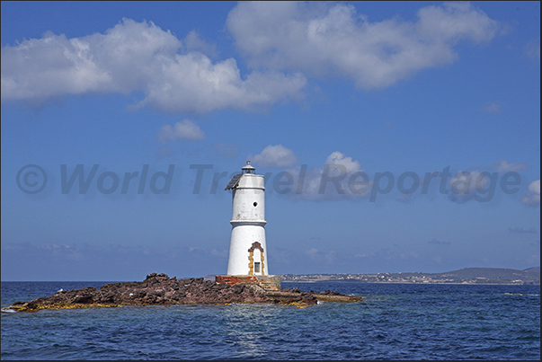 Lighthouse of Punta Maggiore with behind Saint Pietro island Lighthouse of Punta Maggiore with behind Saint Pietro island