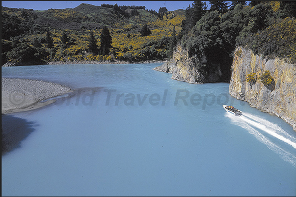 Jet Boat in the gorge on the blue waters of Rakaia River Jet Boat in the gorge on the blue waters of Rakaia River