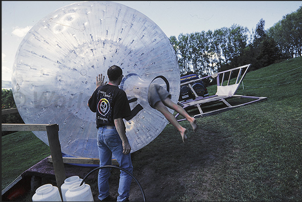 Entry into the Zorb, the large transparent plastic ball which to descend from the hill Entry into the Zorb, the large transparent plastic ball which to descend from the hill
