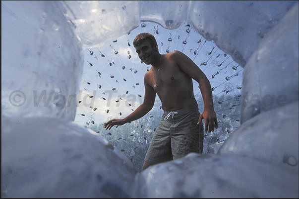 Entry into the Zorb, the large transparent plastic ball which to descend from the hill Entry into the Zorb, the large transparent plastic ball which to descend from the hill
