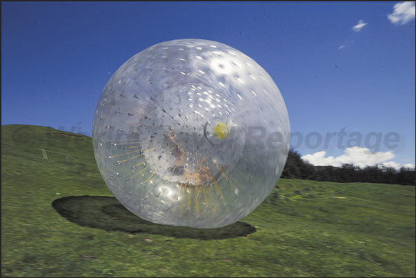 Zorbing. Descent of the hill. Inside the sphere, to increase the fun, there is water Zorbing. Descent of the hill. Inside the sphere, to increase the fun, there is water