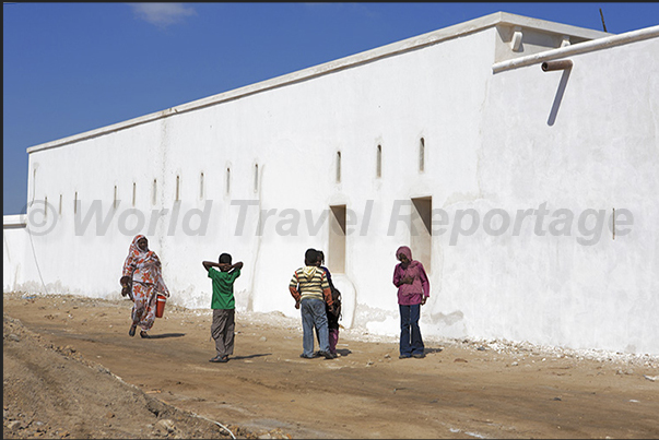 Inside the walls, the main road of the coral city begins to rebuild