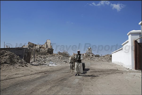 Inside the walls, the main road of the coral city begins to rebuild