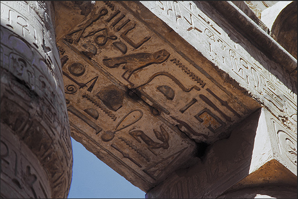 Karnak archaeological site. The large columns of the temple and the hieroglyphs on the ceiling Karnak archaeological site. The large columns of the temple and the hieroglyphs on the ceiling