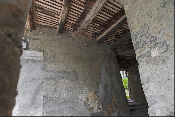 Sospel. Alley Garibaldi, passing under the houses with the typical wooden plank ceiling Sospel. Alley Garibaldi, passing under the houses with the typical wooden plank ceiling