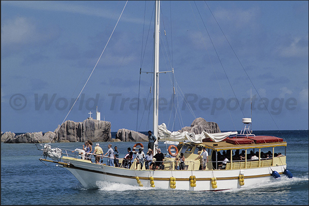 Boat with tourists during a mini cruise around the island Boat with tourists during a mini cruise around the island