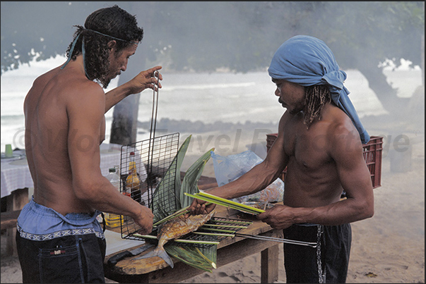BBQ on the beach with freshly caught fish BBQ on the beach with freshly caught fish