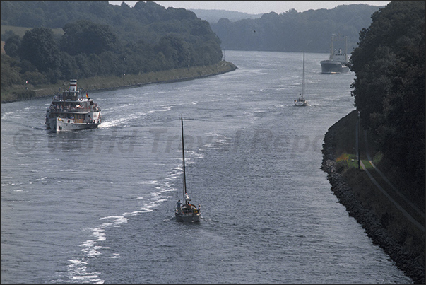 In navigation in Kiel Canal. Merchant ships, wheel steamers and sailing boats In navigation in Kiel Canal. Merchant ships, wheel steamers and sailing boats