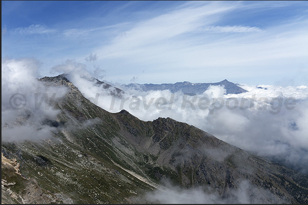 On the tip of the Seguret mountain and on the horizon the tip of Rocciamelone mountain On the tip of the Seguret mountain and on the horizon the tip of Rocciamelone mountain