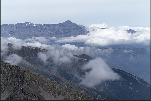 On the tip of the Seguret mountain and on the horizon the tip of Rocciamelone mountain On the tip of the Seguret mountain and on the horizon the tip of Rocciamelone mountain