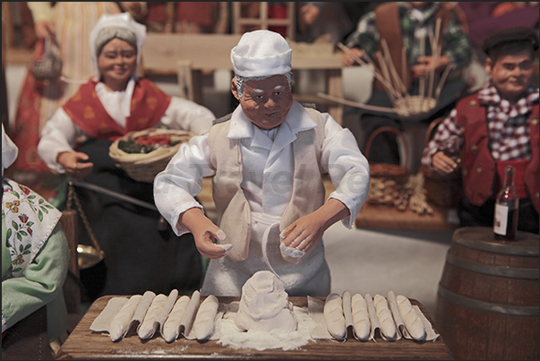 Terracotta figurines representing typical jobs of the village. The baker prepares the baquettes, typical French bread Terracotta figurines representing typical jobs of the village. The baker prepares the baquettes, typical French bread