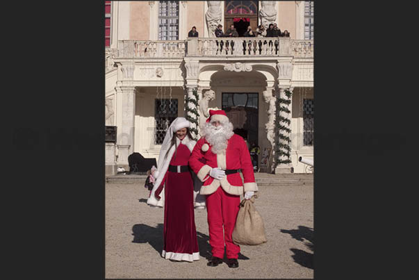Santa Claus and Mother Christmas enter in the castle to listen to wishes of the children Santa Claus and Mother Christmas enter in the castle to listen to wishes of the children