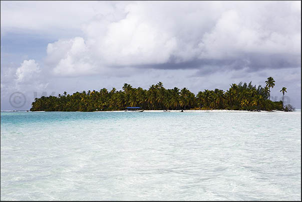 Uninhabited islands on the edge of the lagoon near the coral reef Uninhabited islands on the edge of the lagoon near the coral reef