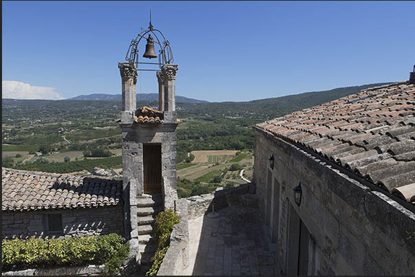 The ancient clock tower in the medieval village of Lacoste The ancient clock tower in the medieval village of Lacoste