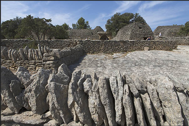 Among the houses are fences for flocks of goats and sheep Among the houses are fences for flocks of goats and sheep