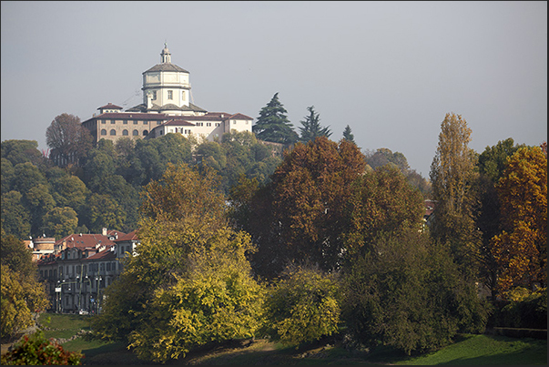 Monte dei Cappuccini in the colors of autumn rises above the Po river Monte dei Cappuccini in the colors of autumn rises above the Po river