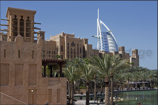 Shopping center in the ancient fortress of Al-Fahdi in the old town of Bastakiya. Behind, the Burj Al Arab, known as The Sail Shopping center in the ancient fortress of Al-Fahdi in the old town of Bastakiya. Behind, the Burj Al Arab, known as The Sail