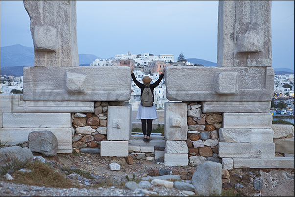 The portal of the temple of Apollo in front of the hill with the ancient citadel of Naxos