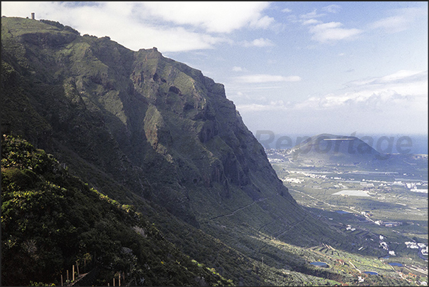 Ancient lava flows form the cliffs around the island sheltering from the winds, banana plantations, the main product of Tenerife