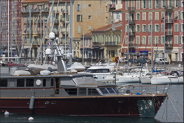 Port Lympia. Ancient and modern boats moored in front of the historic buildings of the Quai des Docks