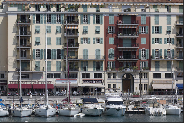 Port Lympia. Ancient and modern boats moored in front of the historic buildings of the Quai des Docks Port Lympia. Ancient and modern boats moored in front of the historic buildings of the Quai des Docks