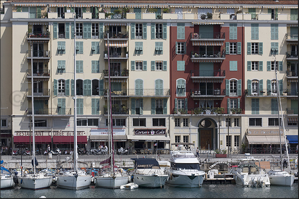 Port Lympia. Ancient and modern boats moored in front of the historic buildings of the Quai des Docks