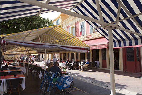 Cours Salaya with restaurants and stalls displaying flowers and handicrafts