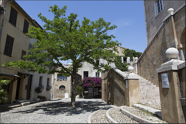 Grimaldi square with the double staircase that goes up to the castle Grimaldi square with the double staircase that goes up to the castle