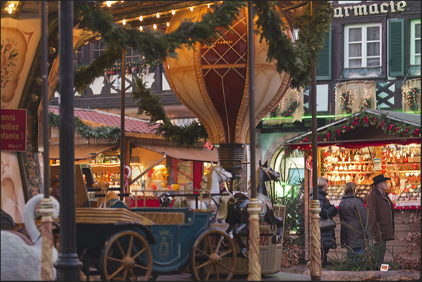 At Christmas, lights and colors decorate the old squares of the little town of Obernai. A old carousel in the Market Square At Christmas, lights and colors decorate the old squares of the little town of Obernai. A old carousel in the Market Square