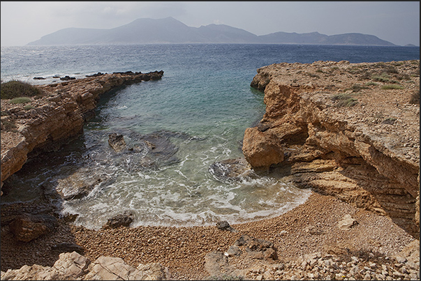 Low cliffs and small beaches characterize the south east coast. On the horizon the uninhabited island of Keros Low cliffs and small beaches characterize the south east coast. On the horizon the uninhabited island of Keros