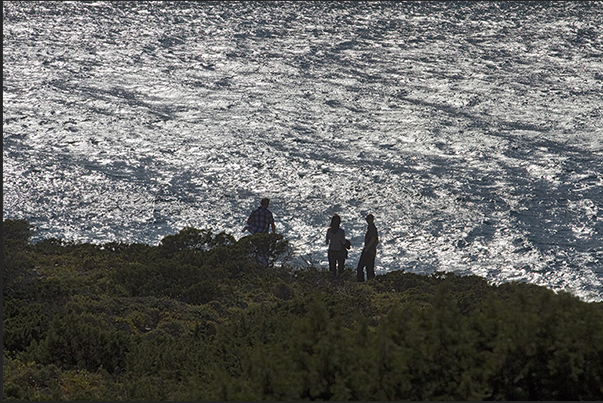 Stroll along the north coast towards the bay of Vourkaria under the caves of Agios Ionnis and Poliphimos