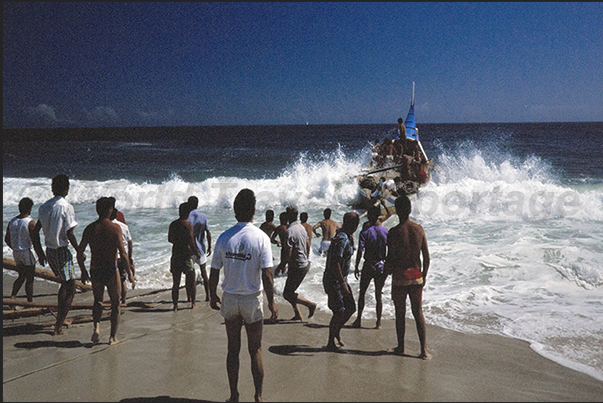 The boat perilously rides up on the wave and nearly capsizes