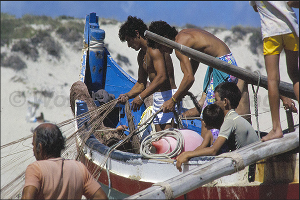 The fishermen and their families begin to prepare the boats and going out to sea The fishermen and their families begin to prepare the boats and going out to sea