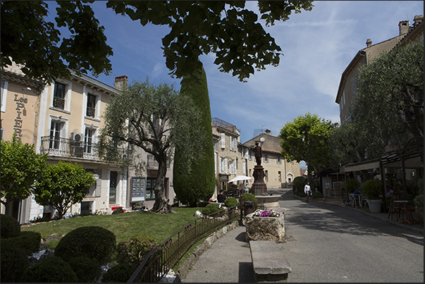 Place du Commandant Lamy, the main square of the village Place du Commandant Lamy, the main square of the village