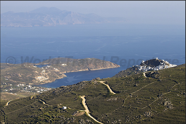 On the tip of the hill Chora (Hora) the capital of the island overlooks the bay of Livadi. On the horizon the island of Sifnos On the tip of the hill Chora (Hora) the capital of the island overlooks the bay of Livadi. On the horizon the island of Sifnos