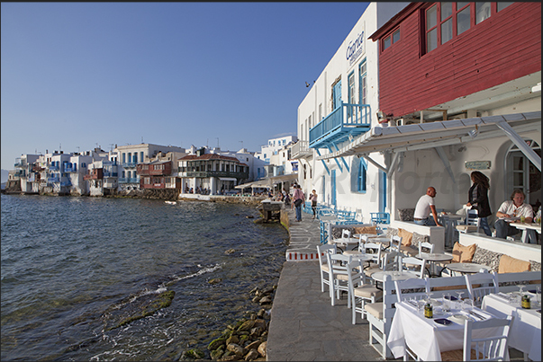 Walk along the seafront of the ancient village of Mykonos