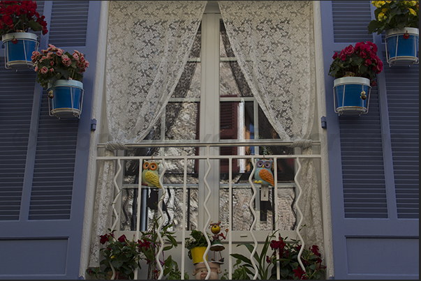Vases of flowers decorate the windows in the streets of the village Vases of flowers decorate the windows in the streets of the village