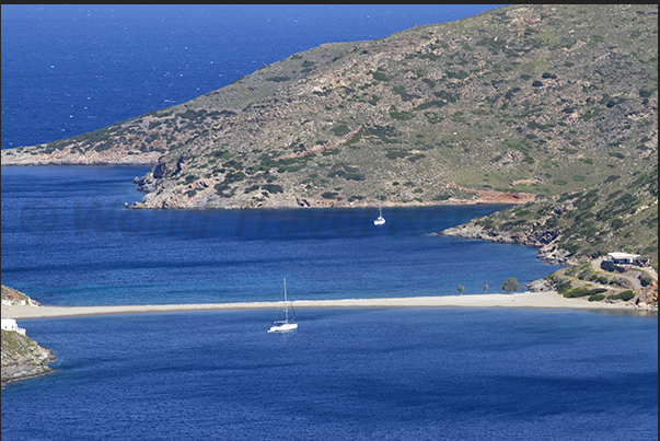 Apokrousi Bay with the sandy strip that connects the coast to the island of Kolona Apokrousi Bay with the sandy strip that connects the coast to the island of Kolona